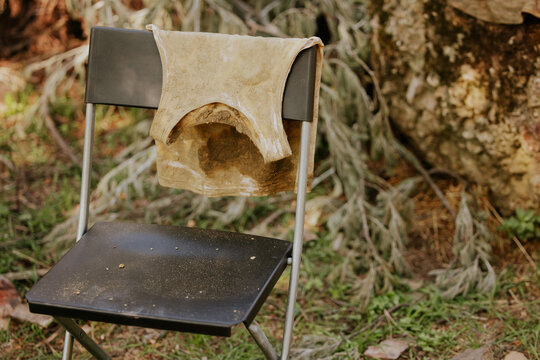 Old chair with dirty cloth in outdoor setting