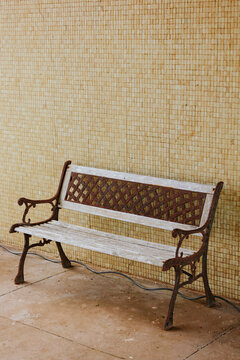 Vintage garden bench with decorative wall tiles