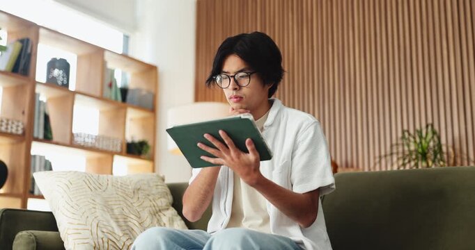 Remote work, think or man with tablet for planning, check aesthetic feedback or website maintenance idea. Email, reflection or Asian person with tech in home, project brainstorming or system revision