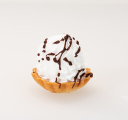 Fototapeta premium Delicious dessert basket with whipped cream and chocolate syrup