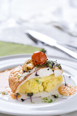 Gourmet fish fillet serving with mashed potatoes and cherry tomato