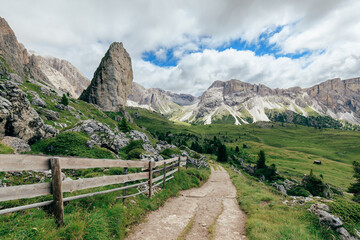 Hiking trail through Alpine meadows in Dolomites, Italy