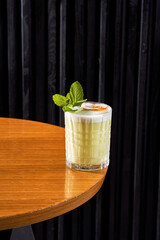 Refreshing orange citrus cocktail in a crystal rocks glass on a dark background