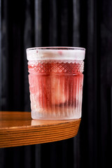 Refreshing orange citrus cocktail in a crystal rocks glass on a dark background