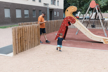 Father distracted by phone while son playing