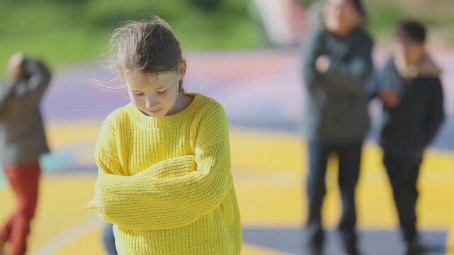 Sad lonely girl bullied at school playground