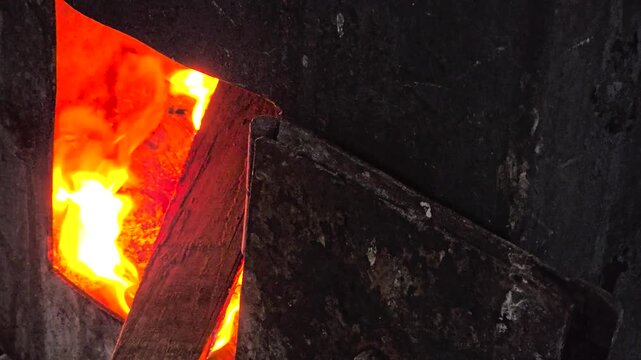 A wood-burning stove and burning logs