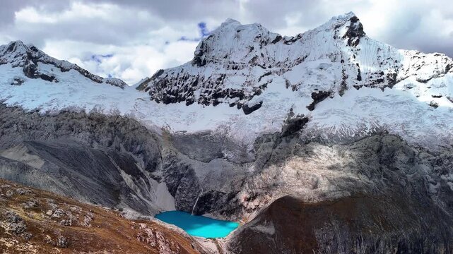Aerial drone view of Laguna 69 in Huaraz, Peru. Stunning glacier lake 69 surrounded by dramatic mountain landscape.