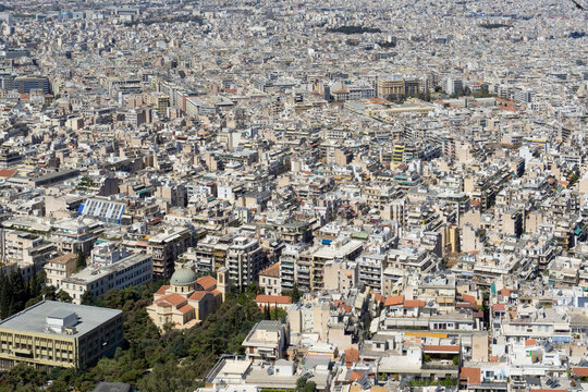High Angle View of Dense Urban Cityscape in Athens Greece Featuring Traditional Mediterranean Apartment Blocks and a Historic Domed Church in the Heart of the City