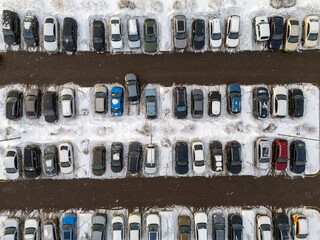 Winter car packing top view. Colorful cars in a snowy parking lot in winter. High quality photo