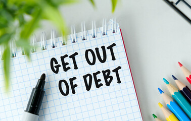 GET OUT OF DEBT text on paper with colored pancils on white background