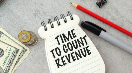 Text Time To Count Revenue on financial tables with pen and paper clips.