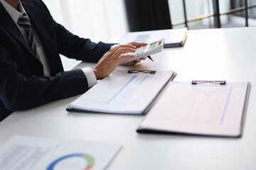 Businessman working in office calculating tax.
