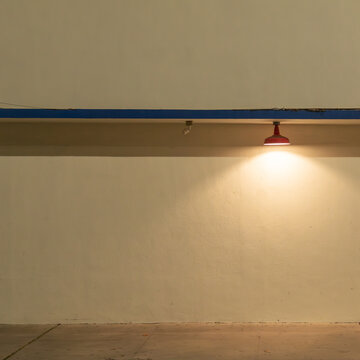 Minimal interior wall with spotlight and warm light, modern architectural background 