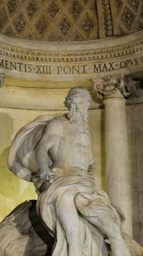 tightly framed night trevi fountain central niche marble statue oceanus lighting defines view rome italy roman empire emperor dramatic sculptural detail 