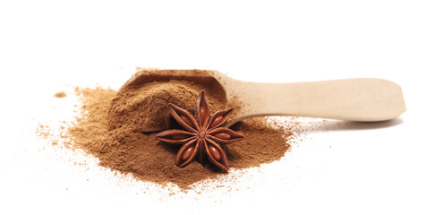 Pile cinnamon ground in wooden spoon with star anise isolated on white background, side view