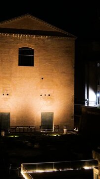 stark night time solitary rectangular brick building triangular pediment plain facade subtle lighting defines rome view italy roman empire emperor scene fa ade 