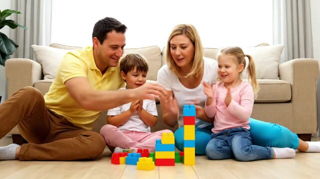Joyful family playtime: Parents and two happy children building colorful towers with toy blocks on the living room floor, fostering creativity and bonding. 4k Video