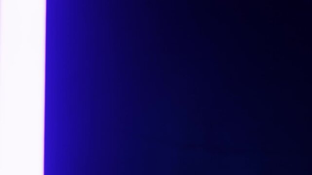 Glowing purple lightsaber blade activates and deactivates. The bright neon light illuminates a dark, solid background, creating a futuristic effect.