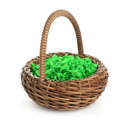 Obraz premium Wicker Easter basket with green shredded paper filling isolated on white