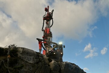 a large rock drill at work in a quarry