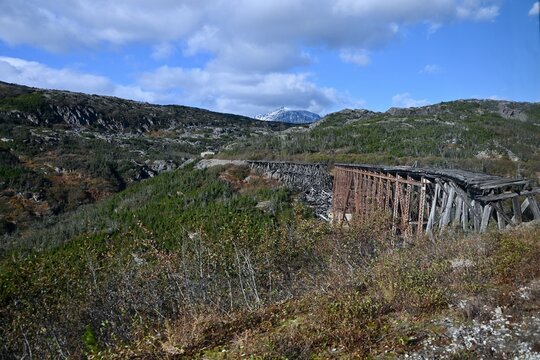 a train passes over an old trestle in Alaska