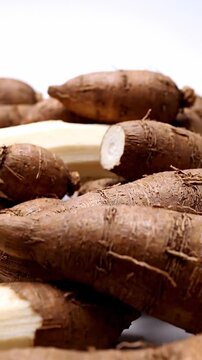 Pile of Fresh Cassava Roots on White Background, Close-Up Studio Shot