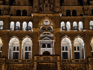 illuminated tower exudes historic grandeur, golden arches and detailed stone carvings shine brightly © Nataliia