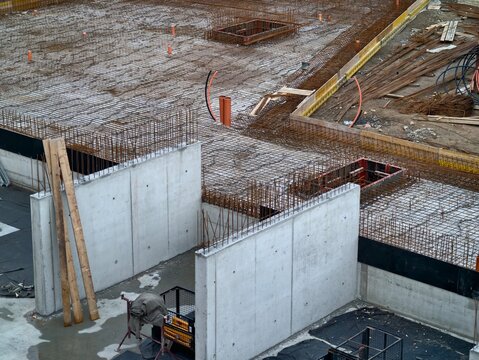 site view of slab and wall construction, initial stage of foundation with framing and connections
