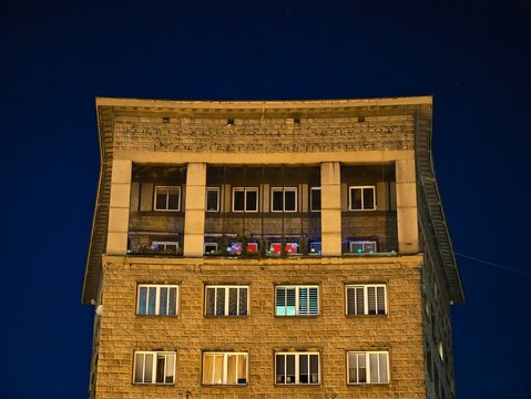 quiet urban building with nostalgic ambiance, serene city block illuminated by cozy yellow lights