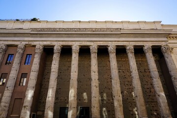 Naklejka premium Front facade and colonnade of the landmark Hadrianeum, temple of Hadrian, with its ancient Roman columns in Rome, Italy