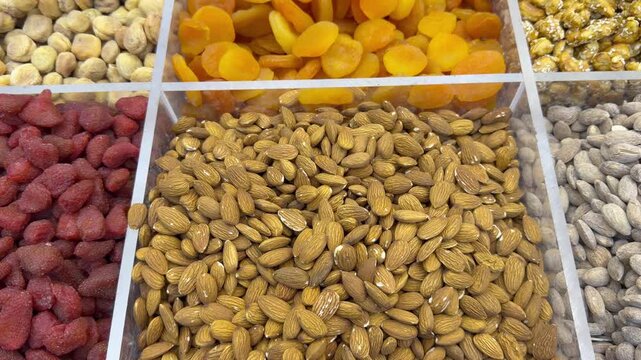 A colorful dry‑food display in Dubai&rsquo;s Deira Old Souk, showcasing spices, nuts, and grains in vibrant arrangements.