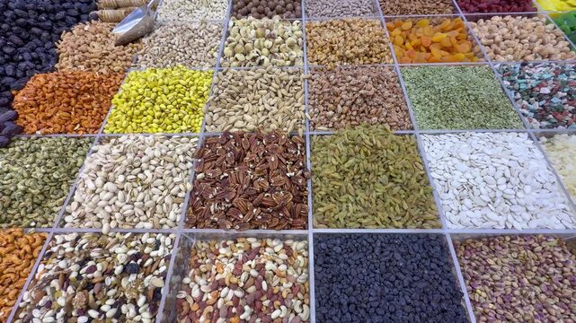 A colorful dry‑food display in Dubai&rsquo;s Deira Old Souk, showcasing spices, nuts, and grains in vibrant arrangements.