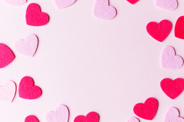 Stylish valentine hearts flat lay. Pink and red hearts on pink paper background, love banner. Happy Valentine's day card with space for text