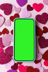 Valentine's day phone mockup. Empty phone screen flat lay with stylish pink and red glitter hearts on pink paper background. Happy Valentine's day smartphone template with space for text