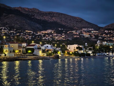 Silent coastal settlement under starry sky, Calm fishing hamlet illuminated by lanterns at dusk