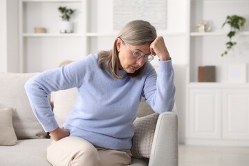 Amnesia. Senior woman trying to remember something at home