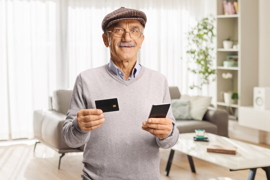 Elderly man with a credit card and smartphone