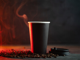 Paper cup of hot coffee on a dark wooden table. Roasted coffee bean