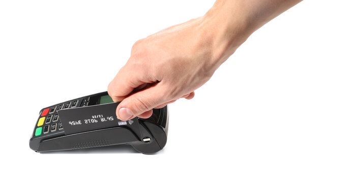 Man with credit card using payment terminal on white background, closeup