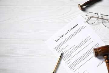 Last Will and Testament, gavel, glasses, wax stamp and pen on white wooden table, flat lay. Space...