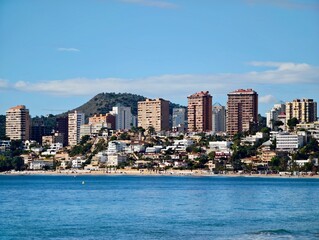 Fototapeta premium Seaside community with apartments, Coastal residential area with sandy beaches and green spaces