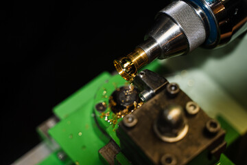 Gold ring milled accurately by jeweler using machine.