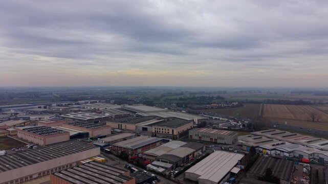 Aerial view of industrial park warehouses under cloudy sky
