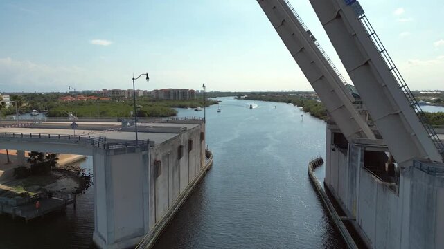 Raised Bascule Drawbridge Over Intracoastal Waterway with Coastal Mangroves and Transit Traffic in North Palm Beach.
