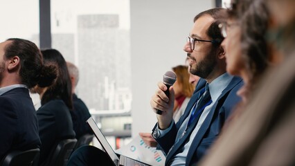 Audience engagement through raising hand, asking questions and listening during panel discussion....