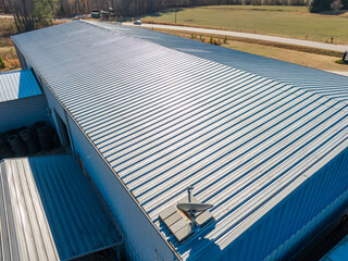 High Resolution Aerial Drone View of Gray Standing Seam Metal Roof On Commercial Building © Oak City Drone