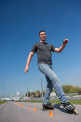 A Caucasian man rollerblades around the slalom course.