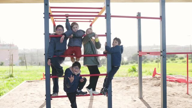 Group of children playing together on playground monkey bars