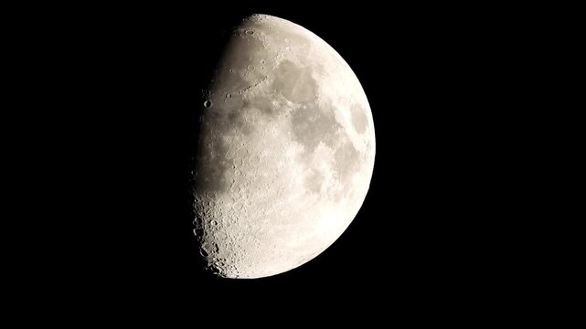A close-up of the Moon dominates the frame, more than half illuminated in a gibbous phase. The surface reads like a weathered, pocked landscape